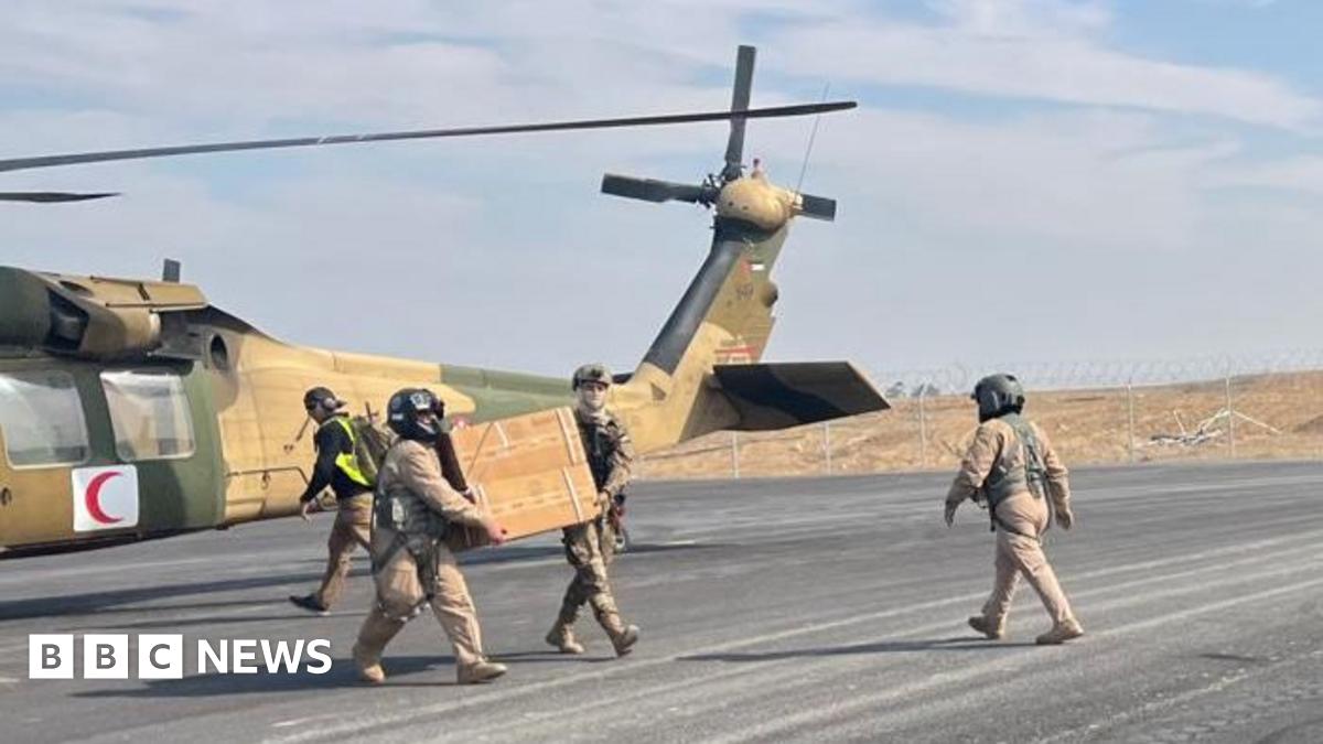 Medical supplies and baby formula are unloaded from a Jordanian helicopter at an airstrip in Israeli-held southern Gaza (28 January 2025)