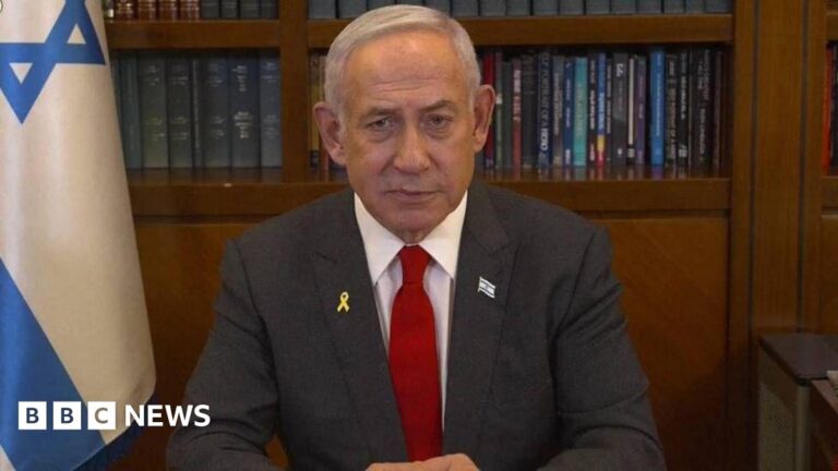 Netanyahu looks at the screen as he addresses the Israeli nation.
