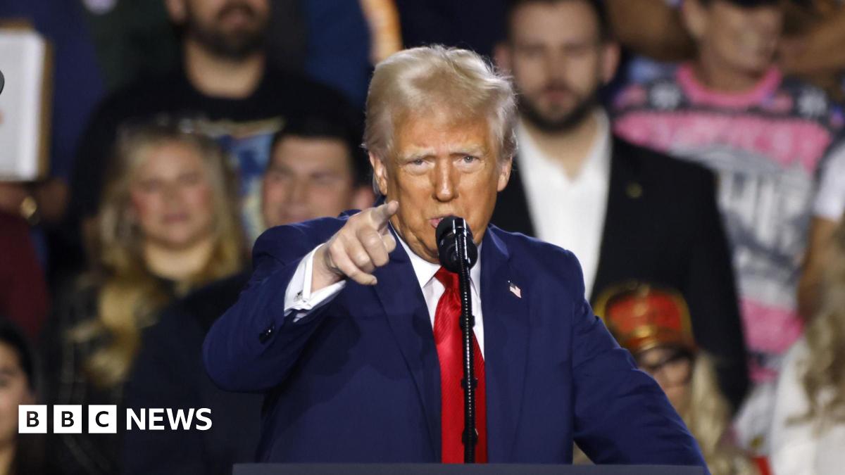 Donald Trump, wearing a blue suit and red tie, gestures with his right hand as he speaks at an event in Las Vegas on 24 January