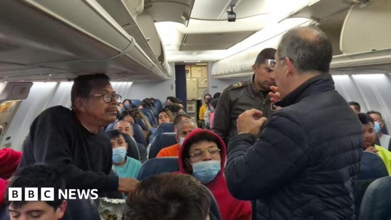 Gustavo Petro, wearing a blue jacket and facing away from the camera, speaks to migrants who were deported from the US on board a Colombian air force plane
