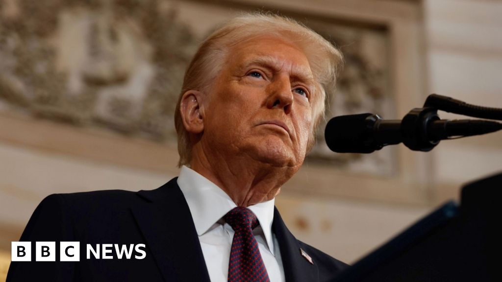Donald Trump looks up from a podium in a close-up.