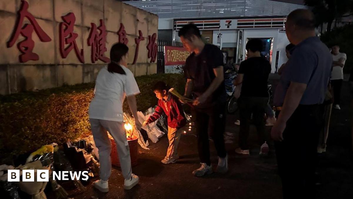 Mourners laid flowers outside the stadium in Zhuhai after the attack