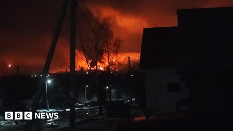 A photo of a dark night sky lit up by red flames