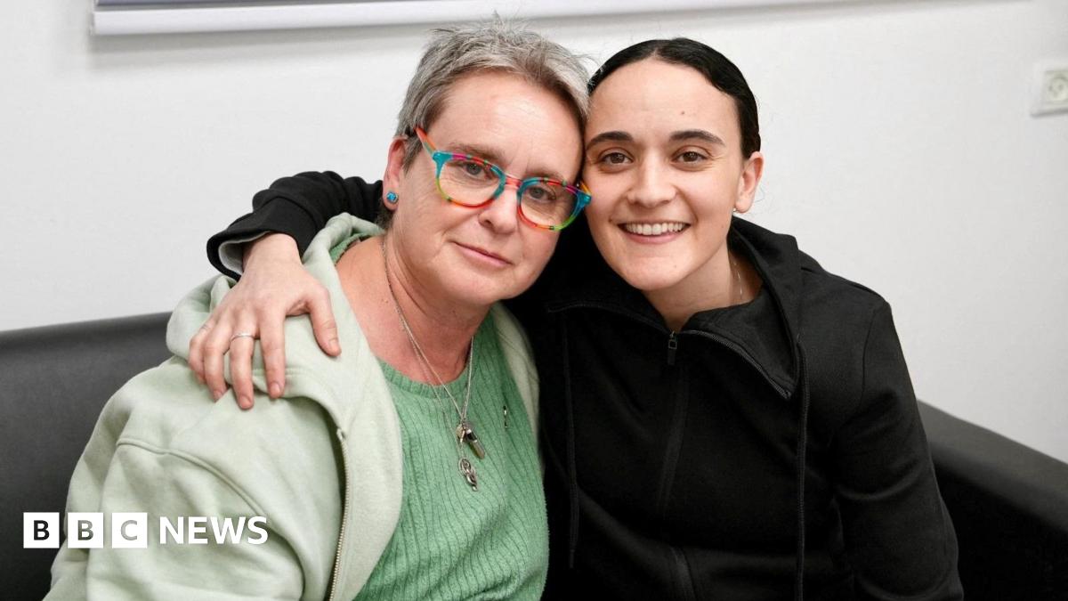 Emily Damari smiles into a camera beside her mother Mandy