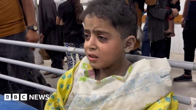 An explosion behind a man entering a building