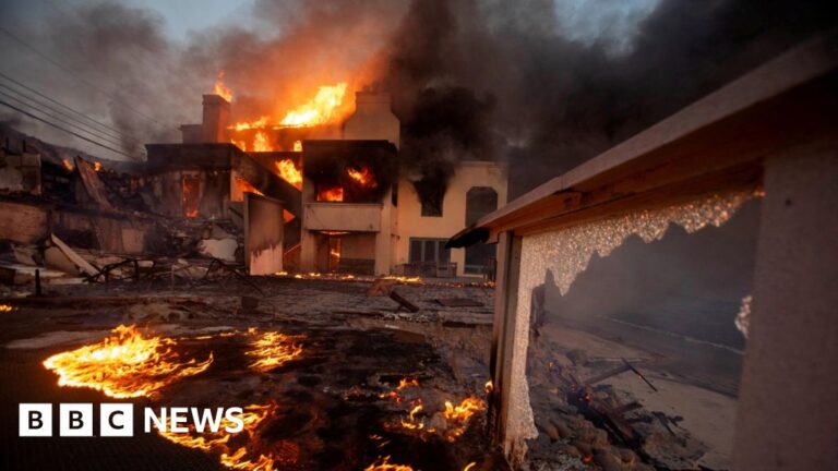 A raging inferno blazes inside the shell of a house