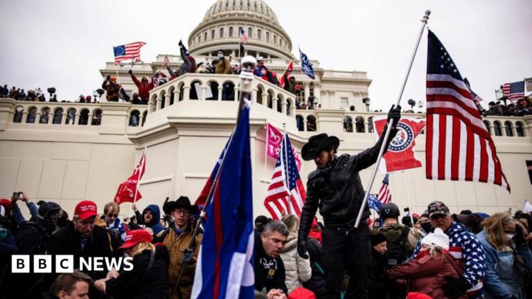 A crowd of rioters storm the US Capitol on 6 January 2021