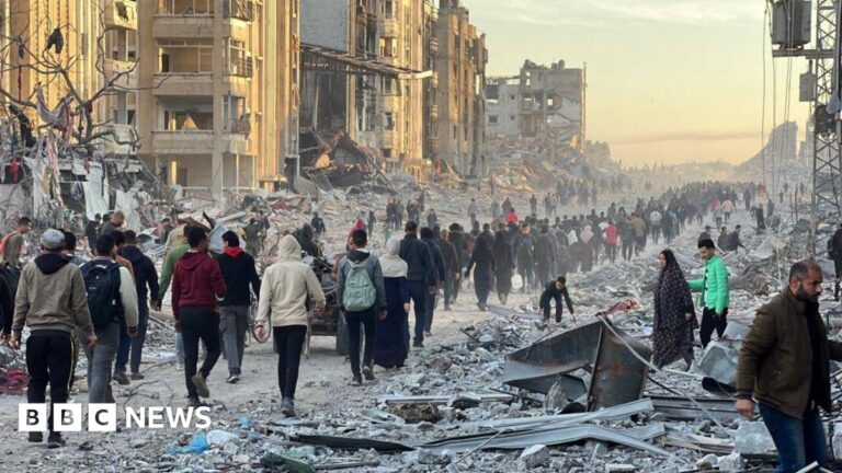 Palestinians in Jabalia walk among debris as they return to their houses after the announcement of ceasefire and hostage-prisoner swap deal between Hamas and Israel
