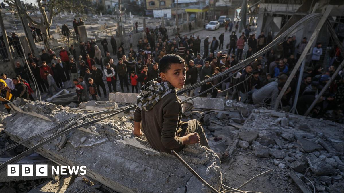 A Palestinian boy sits on rubble following Israeli airstrikes on Al Nuseirat refugee camp, central Gaza