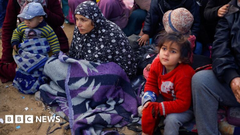 Palestinians wait to be allowed to return to their homes in northern Gaza after they were displaced to the south at Israel
