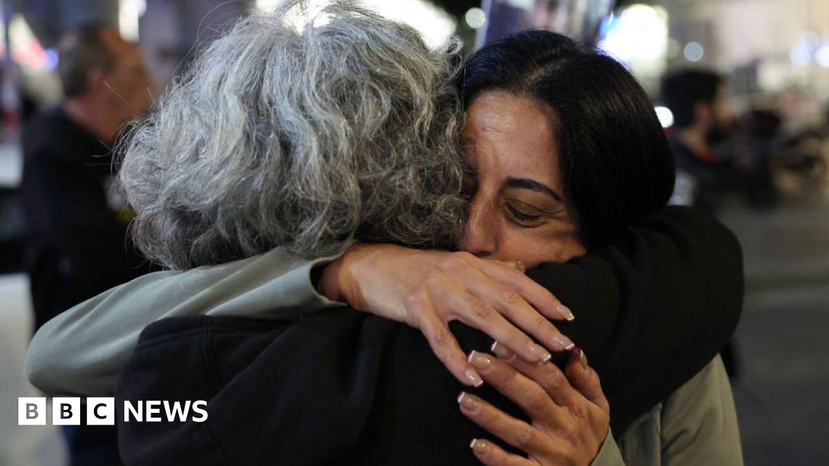 Two women embrace at a public demonstration after ceasefire and hostage deal was agreed