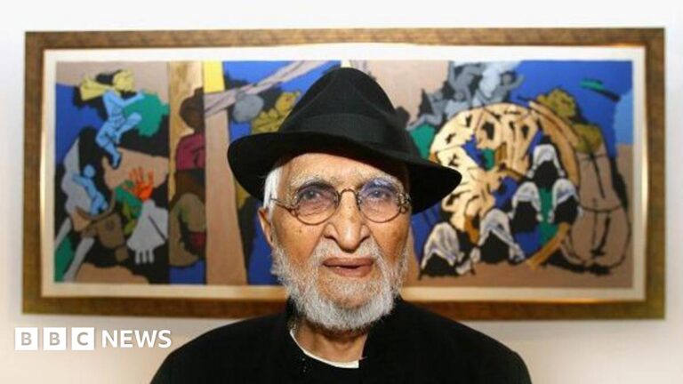 Indian artist MF Husain wearing a black jacket with white shirt and a black hat poses in front of one of his paintings in Raan bar at the O2 Arena on July 3, 2007 in London