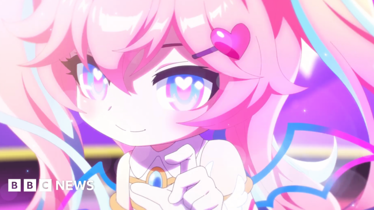 A close up of a video game character with pink hair and a heart hair clip. The character is holding her finger and thumb close together.