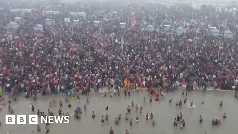 Large crowd of people on river bank