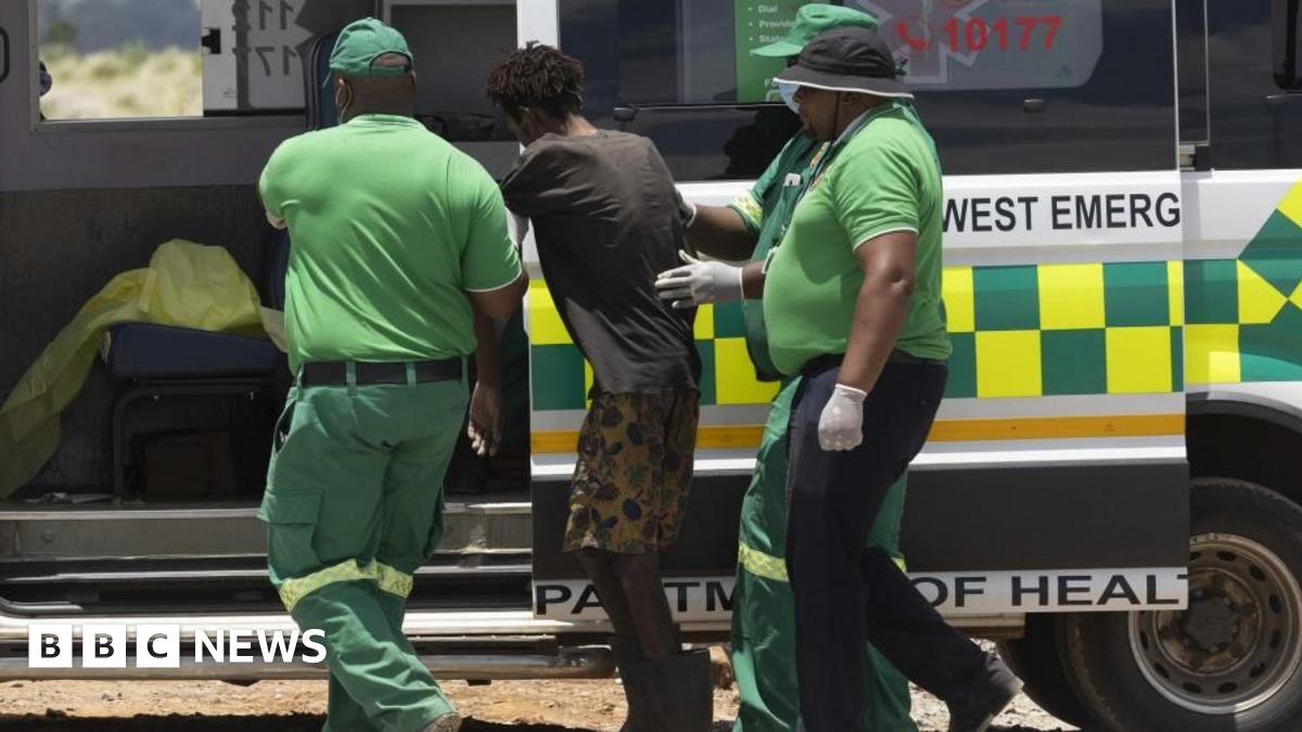 An emancipated miner is brought to a waiting ambulance after being rescued
