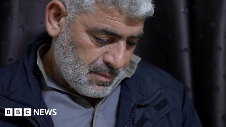 Tearful old man looks down. Tear shows on his cheek.