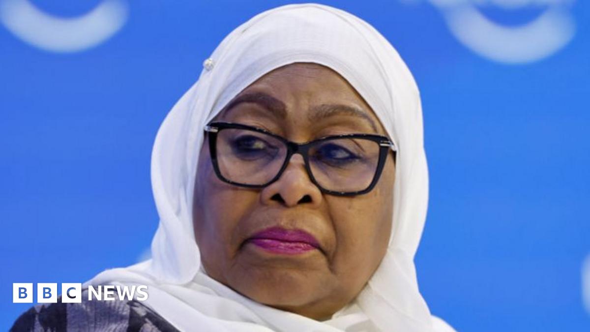 President Samia Suhulu Hassan wears black-rimmed glasses and pink lipstick at a panel discussion