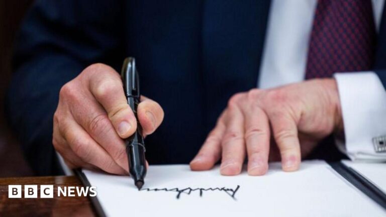 Donald Trump signs executive orders on Monday after being sworn in as president for a second term.