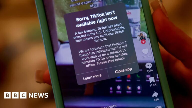 A person holds an iPhone with a message on their TikTok app