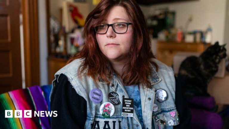 Lauren Handy, pictured in 2022 wearing glasses and a sleeveless denim jacket covered in anti-abortion campaign badges