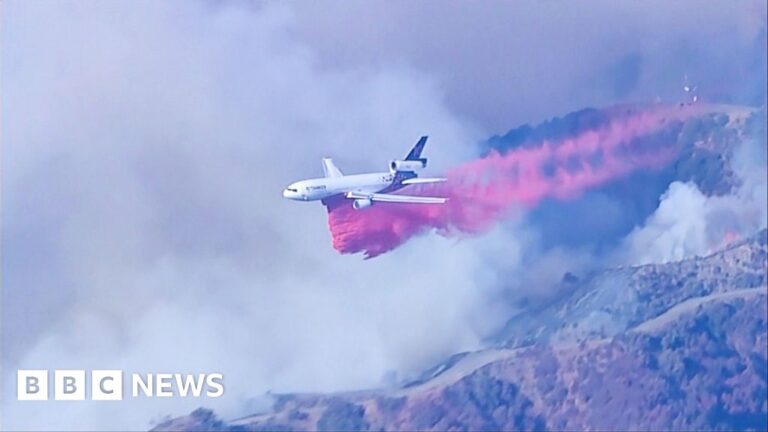 Plane drops fire retardant in path of LA wildfire