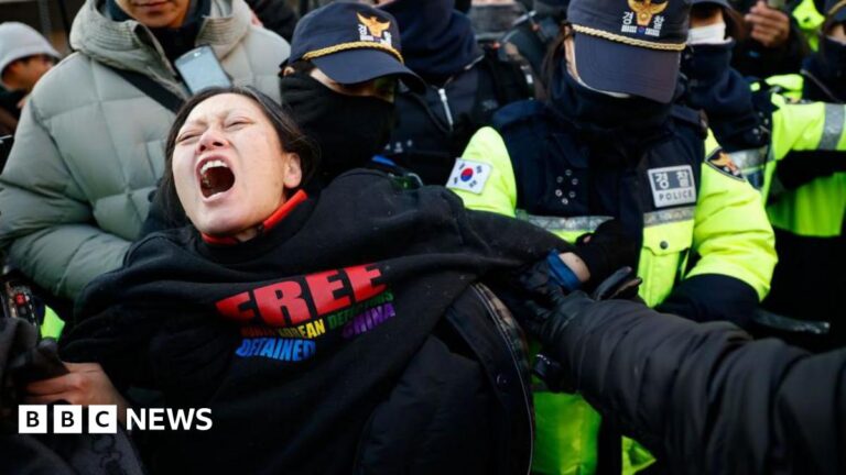 Police officers remove supporters of impeached South Korean President Yoon Suk Yeol from outside his official residence in Seoul, South Korea, on January 2, 2025.