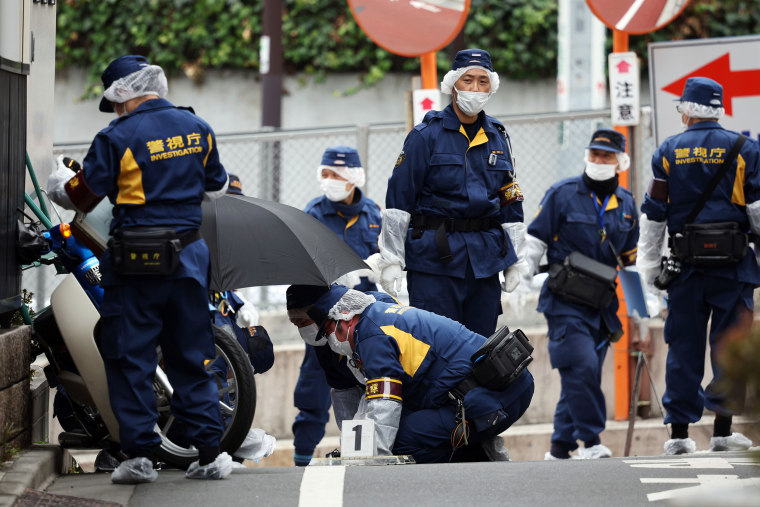 Woman peeled by men in Shinjuku, Tokyo, Japan