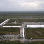 Work progress in a dolbed prisoner facility "Alligator Alcatraz," Took everglades on July 4, 2025, in Ochopee, flag.