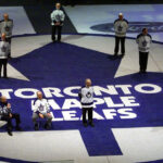Former Toronto Maple Leafs and hall of famers gather on a Leafs logo at centre ice in Maple Leaf Gardens. (Kevin Frayer/CP)