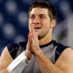 Tim Tebow held a workout for MLB teams in hopes of landing a job in pro baseball. (Elise Amendola/AP)