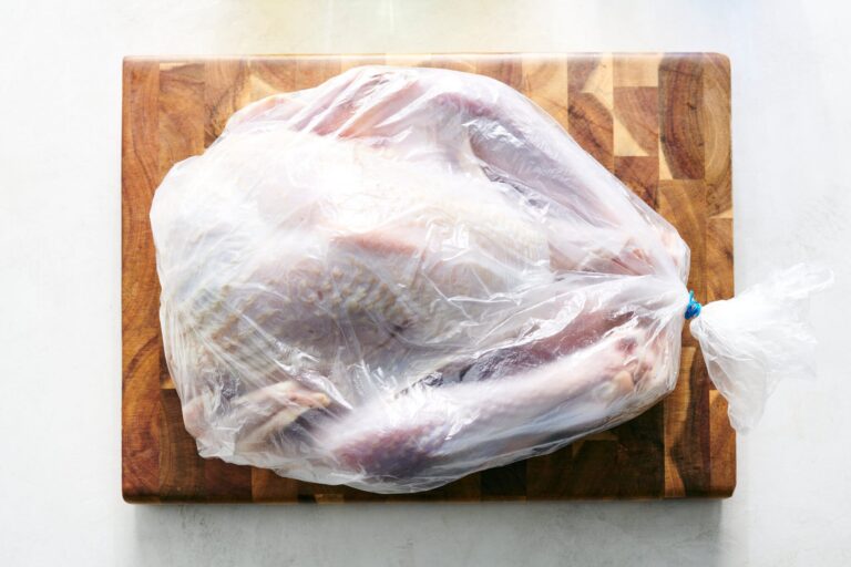 Top view of turkey wrapped in a plate.