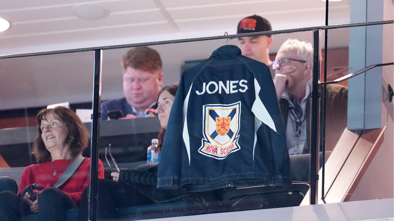 Jones' jacket hangs in the suit while the family looks on at the Canadian Curling Trials
