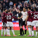 The referee, Darren England shows a yellow and red card to Lucas Paquesta of West United States during the Premier League match between ...
