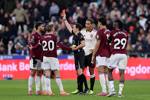 The referee, Darren England shows a yellow and red card to Lucas Paquesta of West United States during the Premier League match between ...
