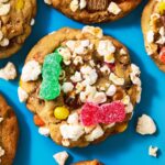 Top view of a half-dozen half-dozen cookies topped with candy and popcorn.